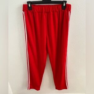 Red jogger pants with 3 white stripes